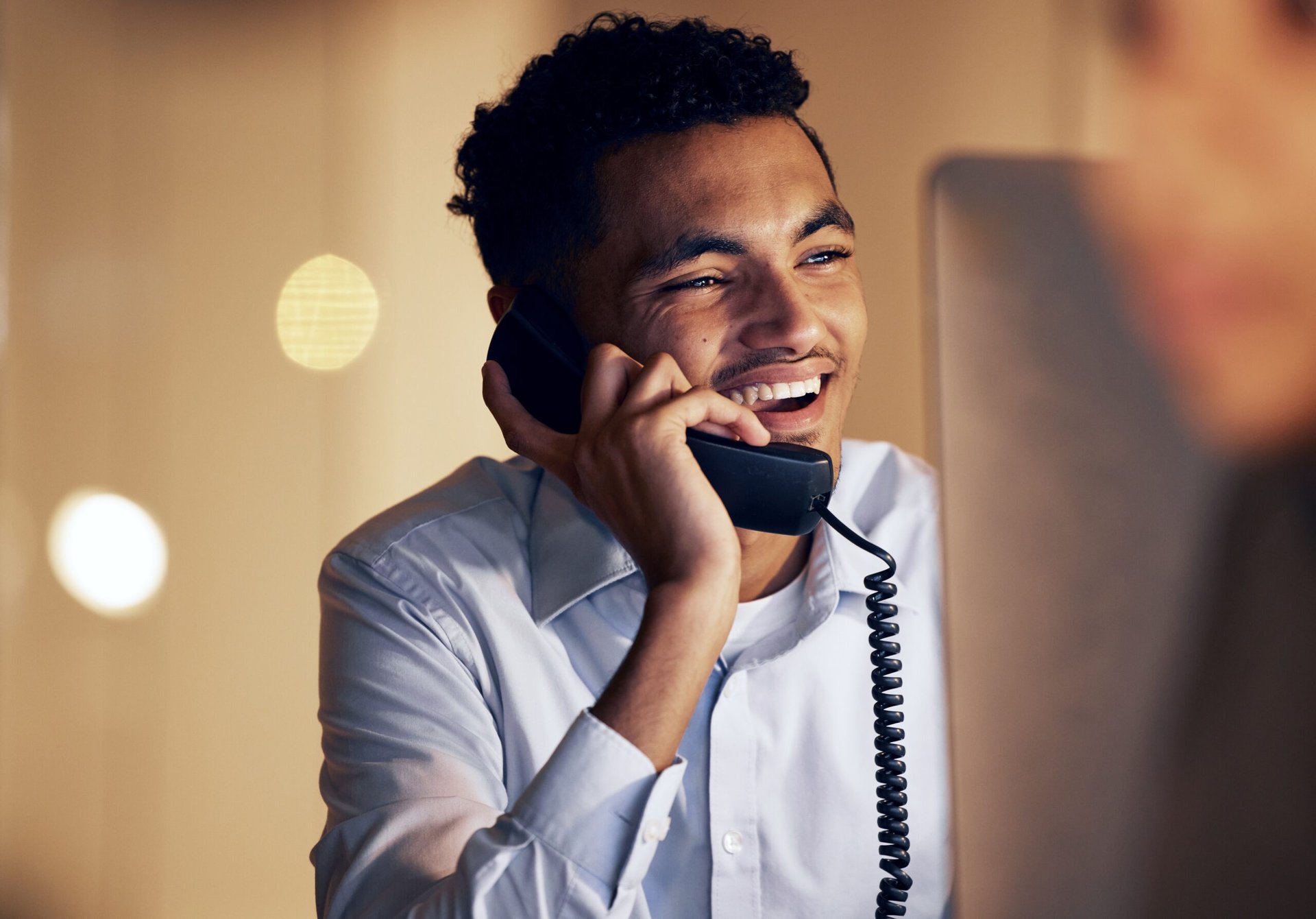 Man on a computer and talking on the phone