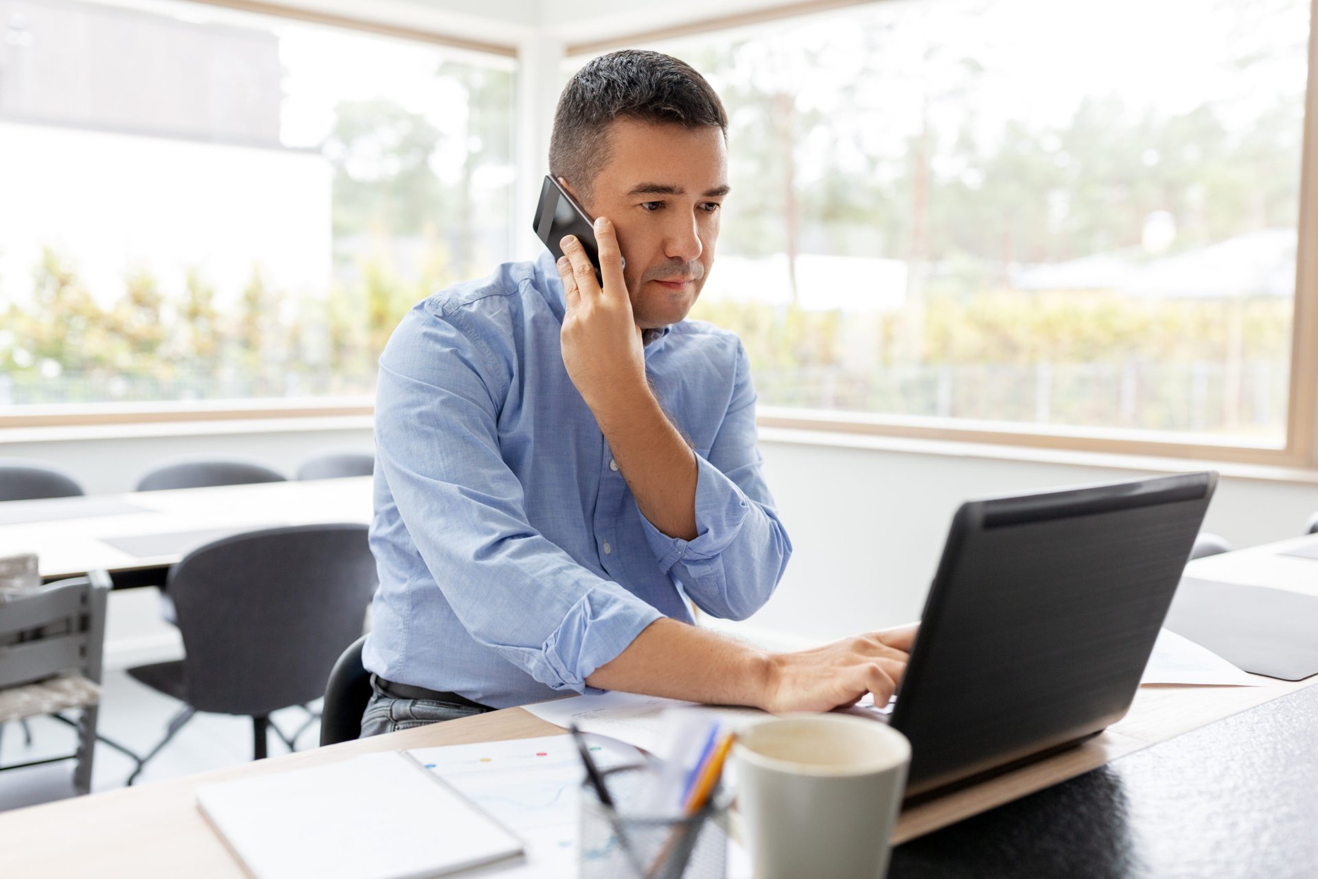 Remote worker on phone and laptop