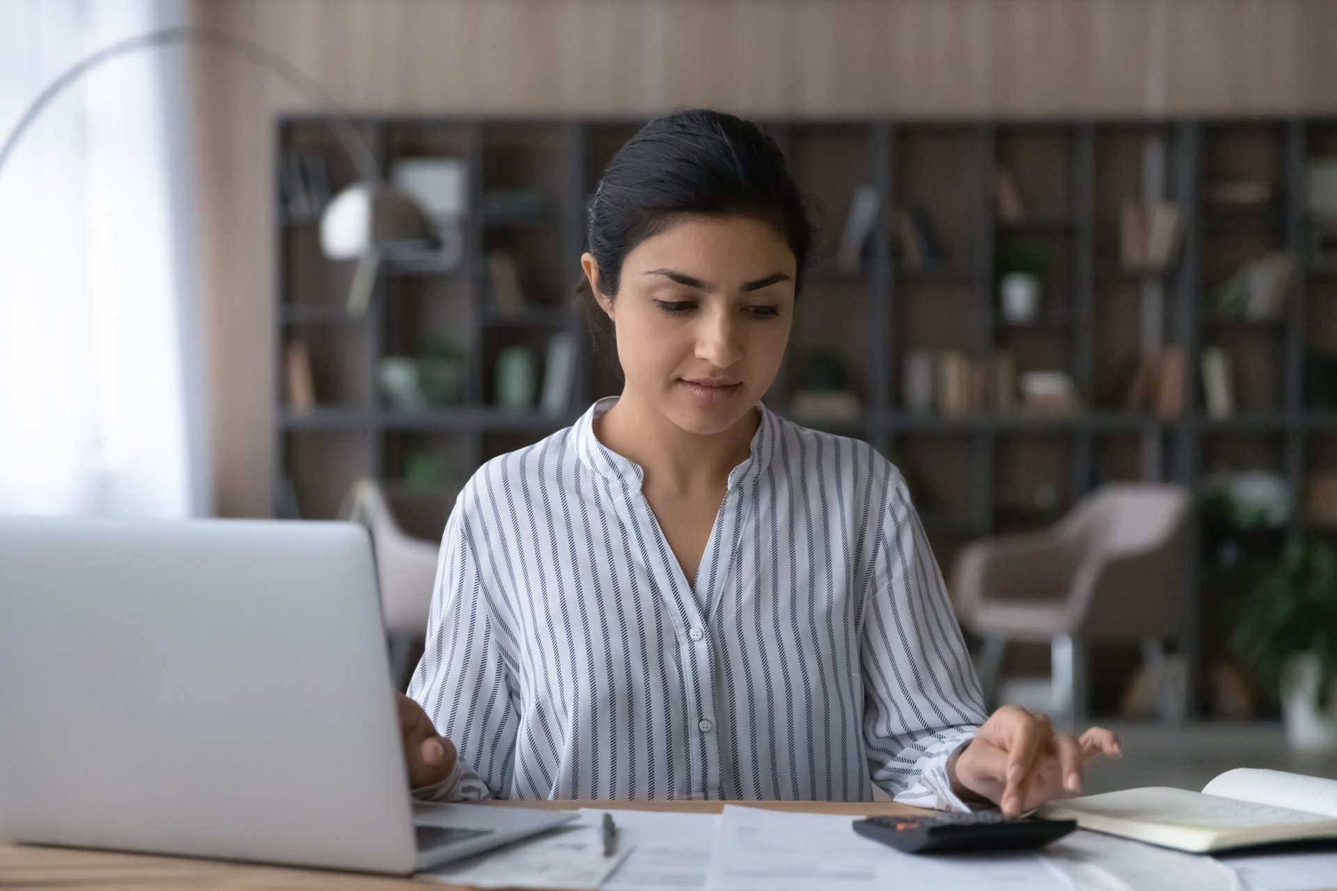 woman working on taxes budgeting paying bills