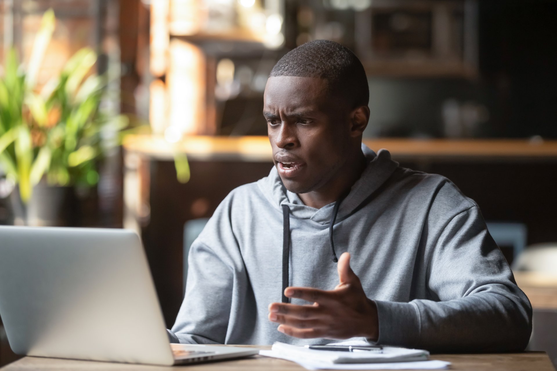 man working at his computer is confused and frustrated